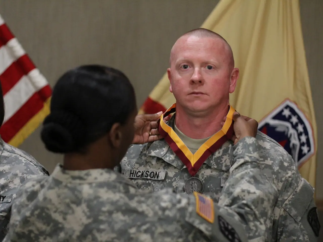 In this picture we can see army & a woman touching the medal of a man standing in front of her. In...