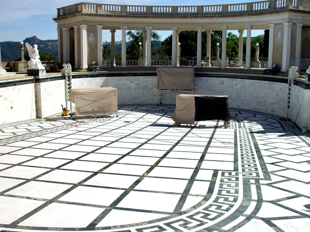 In this image there is a terrace, on that terrace there are three iron tables and there is a...