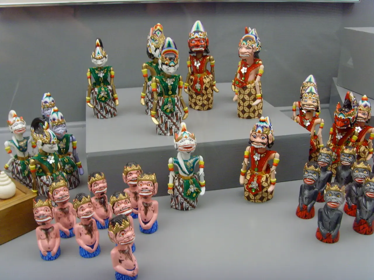 In this image there are puppets which are on the surface which is grey in colour. On the left side...