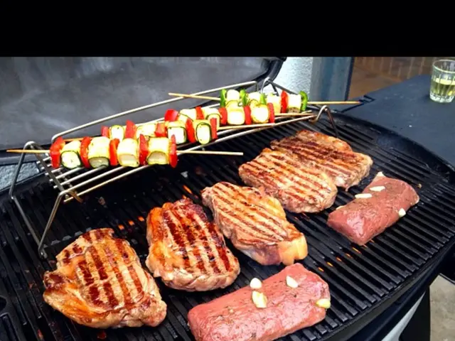 In this picture we can observe black color grill on which some pieces of food were placed. In the...