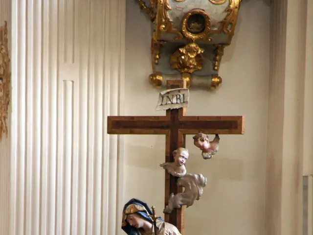 In this image I can see the christian cross symbol and I can see few statues. In the background I...