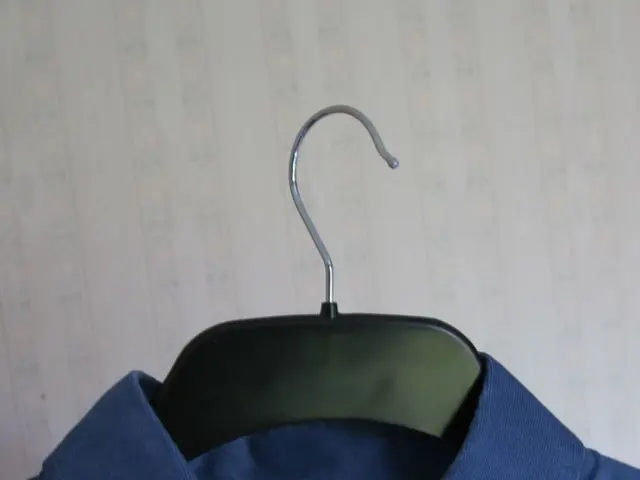 Here in this picture we can see a shirt present in a hanger over there.