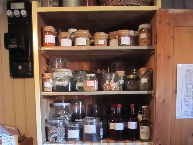 Here we can see jars with stickers on it,wine bottles,dishes,plates,lid on a plate with food in...